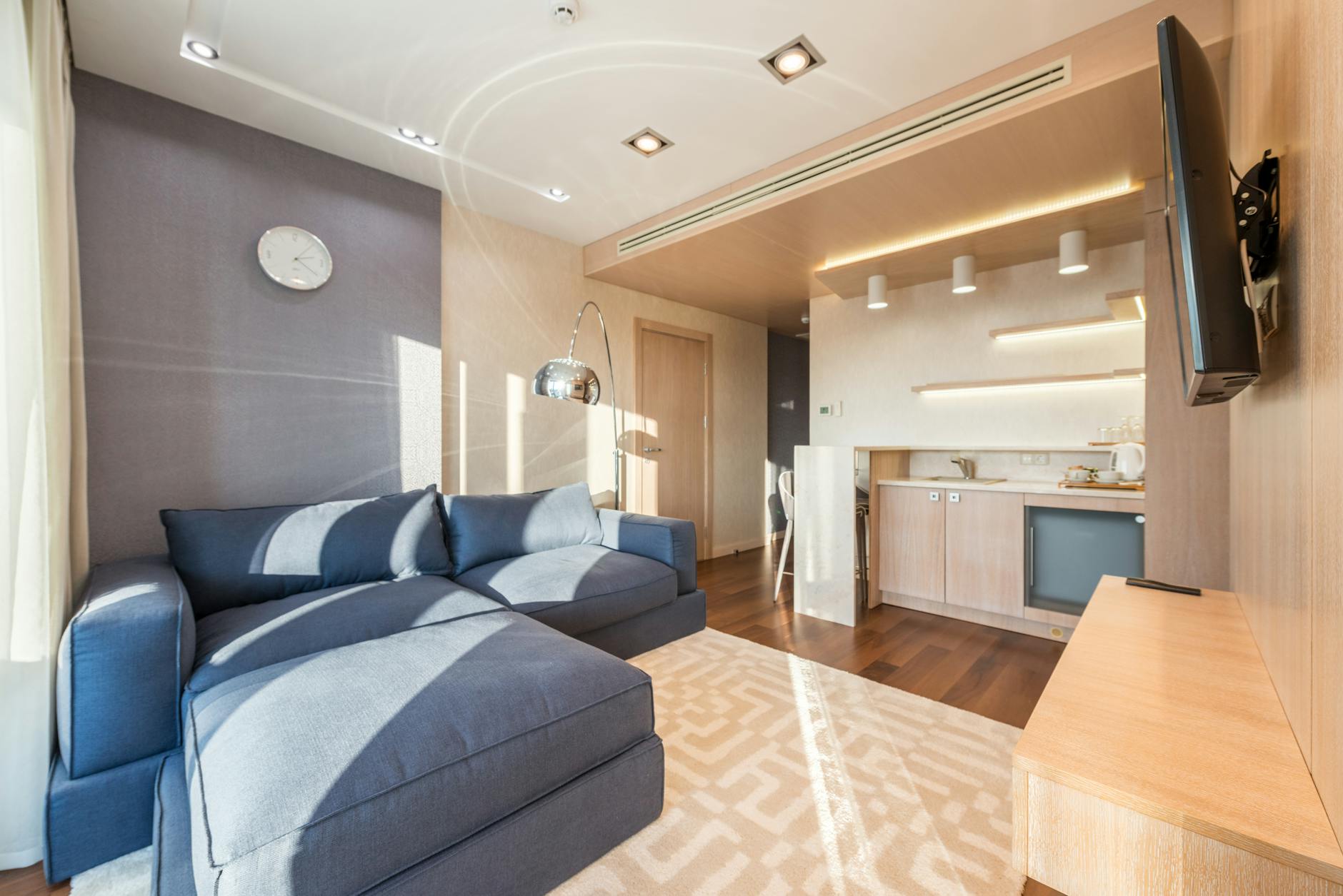 modern apartment interior with comfy sofa and kitchen